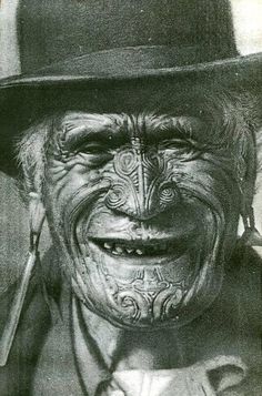 an old photo of a man with painted face and mustaches wearing a top hat