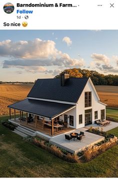 an image of a small house in the middle of a field with a black roof