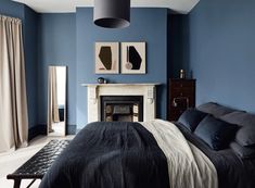 a bedroom with blue walls and black bedding