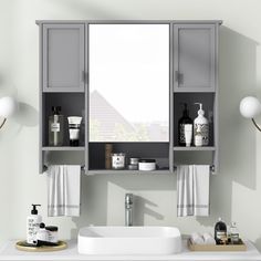 a white sink sitting under a bathroom mirror next to a shelf filled with soap and lotion