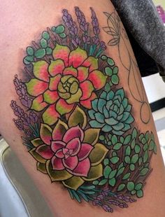 a woman's thigh with succulents and flowers on it