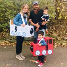 a man, woman and child are posing with a train costume