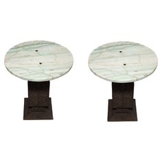 a pair of marble pedestals with metal bases