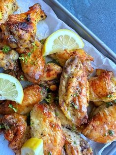 chicken wings with lemon slices and parsley on top