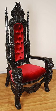 an ornate chair with a red velvet upholstered seat