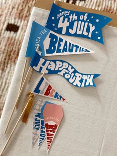 three fourth of july paper flags on a table