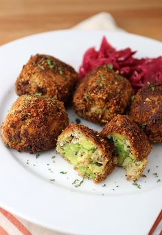 some food is on a white plate with red cabbage