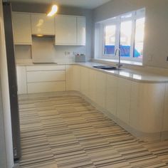 an empty kitchen with white cabinets and counter tops