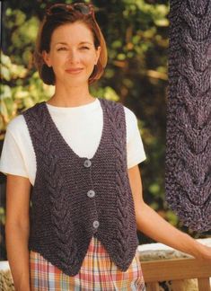 a woman wearing a purple knitted vest and smiling