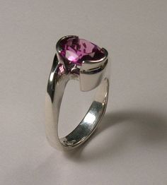 You are looking at a beautiful simulated 10x8 mm oval pink tourmaling. Set in a original contemporary designer ring in sterling silver. The ring features a square European shank which adds weight to the bottom of the ring to help it stay upright. It also adds style and innovation. Comes in sizes from 5 to 8. I am Ernesto an award winning designer, I manufactur all my jewelry. Allow 5 days shipping after order. 7 day money back return. Modern Pink Jewelry With Polished Finish, Modern Pink Gemstone Jewelry, Modern Pink Ring For Formal Occasions, Modern Pink Rings For Formal Occasions, Modern Pink Gemstone Rings, Modern Pink Ring For Anniversary, Modern Pink Rings For Wedding, Modern Pink Jewelry For Anniversary, Modern Pink Promise Ring