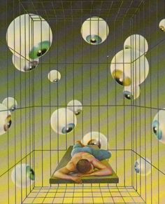 a man laying on top of a bed in a cage with lots of balls hanging from the ceiling