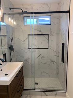 a bathroom with a walk in shower next to a sink