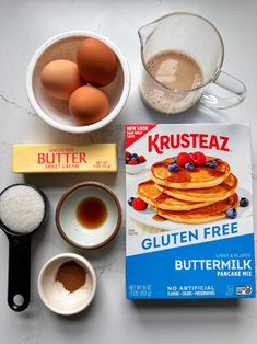 ingredients to make gluten - free pancakes laid out on a counter with eggs and butter