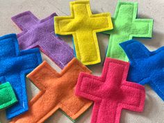 colorful felt crosses laid out on the floor