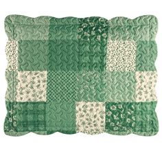 a green and white patchwork pillow on a white background