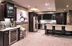 a kitchen with brown cabinets and white chairs