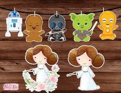 star wars cut outs are hanging on a clothes line with flowers in front of them