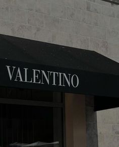 a black and white sign that reads valentino