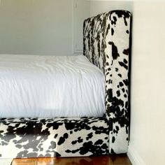 a cow print upholstered bed frame in a bedroom