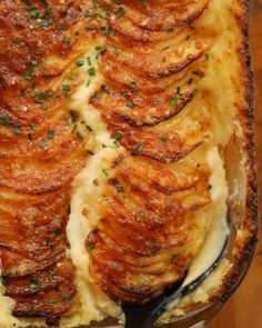 a casserole dish with potatoes and parmesan cheese