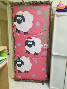 a door decorated with christmas lights and two sheep on it's side, in front of a refrigerator