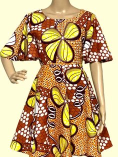 Step into the vibrant rhythms of Africa with this stunning handmade dress adorned in bold, colorful African prints. Crafted with care and attention to detail, this dress celebrates the rich heritage and culture of the continent while adding a touch of contemporary flair to your wardrobe. Whether you're strolling through the city streets or attending a special event, this unique piece is sure to turn heads and spark conversations. Embrace the spirit of Africa and express your individuality with this eye-catching ensemble. Handmade with love! Bohemian A-line Multicolor Dress, Vibrant Fitted Multicolor Dress, Vibrant Multicolor Fitted Dress, Short Sleeve Bold Multicolor Print Dress, Multicolor Bold Print Short Sleeve Dress, Bohemian A-line Multicolor Mini Dress, Bohemian Multicolor A-line Mini Dress, Bohemian Multicolor Mini Dress With Vibrant Print, Multicolor Bohemian Mini Dress With Vibrant Print