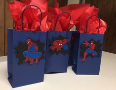 three bags with spiderman on them sitting on a table