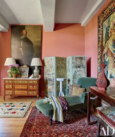 a living room filled with furniture and a painting on the wall