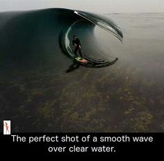 a man riding a wave on top of a surfboard in the ocean with a caption that reads, the perfect shot of a smooth wave over clear water