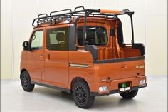 an orange vehicle with a rack on the roof