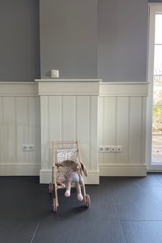 a small child's toy sitting on top of a chair in front of a window