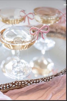 there is a glass with some wine in it on the table next to other glasses