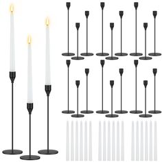 a set of twelve candles with black bases and white candles in the middle, all lit up