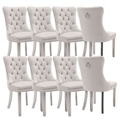 six white dining chairs with buttons on them