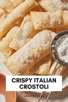 crispy italian crostoli on a white plate with powdered sugar in the middle