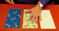 a person sitting at a table with two pieces of fabric on it