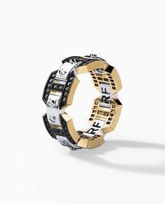 a ring made out of two different types of letters and numbers on the inside of it