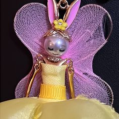 Whimsical Bunny Pendant On This Necklace From Betsey Johnson. Long Gold Chain. Bunny Is Wearing A Yellow Dress And Holds A Basket Off Easter Eggs. Pink Angel Wings. ( Please See Photo As One Wing Has Damage. Green Enamel Flower And Clear Bead On Chain As Well. Matching Earrings Are Posted In My Store As Well. This Rabbit Is An Adorable Princess. Elegant Yellow Necklace For Spring, Handmade Yellow Necklace For Spring, Whimsical Gold Party Necklaces, Handmade Yellow Necklace For Party, Yellow Jewelry For Spring Party, Yellow Spring Party Jewelry, Elegant Yellow Necklace For Party, Spring Party Gold Necklace, Pink Angel Wings