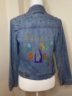 "Hand-painted & customized \"Divine\" denim jacket  Embellished with rhinestones & studs  Handpainted \"Nun\" with flowers Rose patches 🌹💐" Custom Denim Jacket, Rose Patch, Custom Denim, Satin Pillowcase, Flowers Rose, Rhinestone Studs, Denim Jacket, Bathing Beauties, Roses