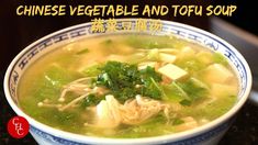 a blue and white bowl filled with soup on top of a table