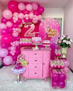 a pink party with balloons and decorations