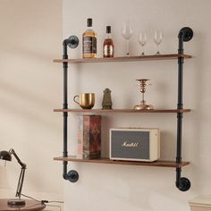 a shelf with wine glasses, an old radio and other items on it in a living room