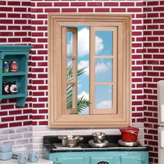 a doll house kitchen with an old fashioned stove and sink in front of a brick wall