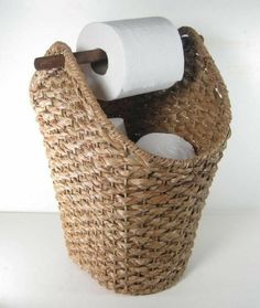 a wicker basket with two rolls of toilet paper in it