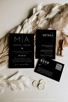 black and white wedding stationery with feathers