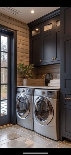 a washer and dryer sitting in front of a window next to a door