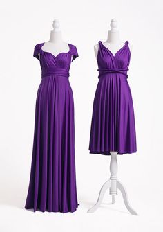 two dresses on mannequins, one in purple and the other in white