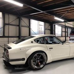 a white sports car parked in a garage