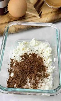 ingredients to make chocolate chip cookies in a glass baking dish next to eggs and flour