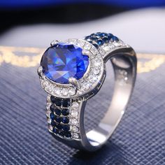 a ring with blue and white diamonds on it